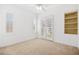 Carpeted bedroom with french doors, built-in shelving, and plantation shutters at 11298 Merado Peak Dr, Las Vegas, NV 89135