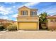 Two-story home with a yellow garage door and well-maintained landscaping at 11298 Merado Peak Dr, Las Vegas, NV 89135