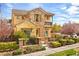 Charming two-story home featuring a stone facade, a small balcony, and a well-manicured front yard at 11298 Merado Peak Dr, Las Vegas, NV 89135