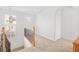 Hallway featuring wood and iron banister and a view of an upstairs window at 11298 Merado Peak Dr, Las Vegas, NV 89135