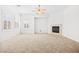 Bright living room with a ceiling fan, fireplace, and plantation shutters at 11298 Merado Peak Dr, Las Vegas, NV 89135