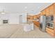 Inviting open-concept space with a modern kitchen, cozy fireplace, and ample natural light, perfect for gatherings at 11298 Merado Peak Dr, Las Vegas, NV 89135