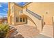 Back patio area with brick pavers, staircase, and water feature at 11298 Merado Peak Dr, Las Vegas, NV 89135