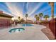 Community pool and hot tub with clear blue water, surrounded by well-kept concrete and a secure fence, lined with palm trees at 1140 Paradise Vista Dr, Henderson, NV 89002