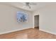 Bedroom featuring laminate flooring, a large window, closet, and light neutral walls at 1405 S Nellis Blvd # 2087, Las Vegas, NV 89104