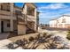 Building exterior featuring stairs leading to a unit with well-kept gravel landscaping at 1405 S Nellis Blvd # 2087, Las Vegas, NV 89104