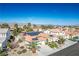 Aerial view of a single-Gathering home with a tile roof, solar panels, and mountain views at 1516 Barrington Oaks St, North Las Vegas, NV 89084