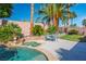 Backyard oasis with a pool, spa, patio with outdoor seating, and lush landscaping at 1516 Barrington Oaks St, North Las Vegas, NV 89084