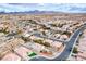 Aerial view showcasing a neighborhood with pools, landscaping, and mountain views at 1516 Dusty Canyon St, Henderson, NV 89052