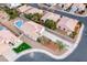 Aerial view of a home showcasing a private pool, well-manicured yard, and spacious driveway at 1516 Dusty Canyon St, Henderson, NV 89052