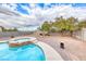 Backyard pool and spa with desert landscaping and secure perimeter walls at 1516 Dusty Canyon St, Henderson, NV 89052