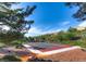 Community basketball court with well-maintained surface and backboards, surrounded by mature trees at 1516 Dusty Canyon St, Henderson, NV 89052