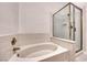 Bathroom featuring a soaking tub and shower with glass door at 1516 Dusty Canyon St, Henderson, NV 89052