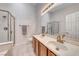 Bathroom featuring double sinks, glass enclosed shower, and modern fixtures at 1516 Dusty Canyon St, Henderson, NV 89052