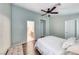 Bright bedroom with hardwood floors, ceiling fan, ensuite bathroom, and walk-in closet at 1516 Dusty Canyon St, Henderson, NV 89052