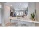 Bright kitchen with a breakfast bar, stainless steel fridge, and access to the dining area at 1516 Dusty Canyon St, Henderson, NV 89052