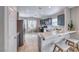 Spacious kitchen featuring a breakfast bar, stainless steel refrigerator, and tile floors at 1516 Dusty Canyon St, Henderson, NV 89052