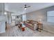 Open concept living area with a ceiling fan, a comfortable sofa, and access to kitchen at 1516 Dusty Canyon St, Henderson, NV 89052