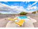 Beautiful backyard featuring a sparkling pool with desert landscaping and ample space for relaxation and recreation at 1516 Dusty Canyon St, Henderson, NV 89052