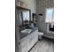 Charming bathroom with patterned wallpaper, elegant vanity, and framed mirror at 170 Magnolia Blvd, Pahrump, NV 89048