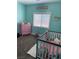 Cozy Bedroom features a white crib, pink dresser, and sweet decorative touches at 170 Magnolia Blvd, Pahrump, NV 89048