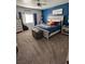 Charming bedroom with a blue accent wall, a statement trunk, a comfy bed, and ample natural light at 170 Magnolia Blvd, Pahrump, NV 89048