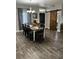 Dining room with wood floors, a large table, and a barn door feature at 170 Magnolia Blvd, Pahrump, NV 89048