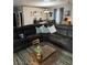 Living room featuring a large sectional sofa, wood accent wall in the adjacent dining area and decor at 170 Magnolia Blvd, Pahrump, NV 89048