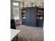 Office area with built-in shelving, carpet flooring, and natural light from the window at 170 Magnolia Blvd, Pahrump, NV 89048