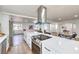 Open kitchen boasts quartz countertops, an island with bar seating, and stainless steel appliances at 1731 Sherwin Ln, Las Vegas, NV 89156