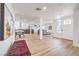 Open-concept living space with wood floors, dining area, and a view of the entryway at 1731 Sherwin Ln, Las Vegas, NV 89156