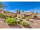 The rear exterior with desert landscaping, mature shrubs and an enclosed patio at 1821 Eagle Mesa Ave, Henderson, NV 89012