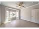 Bedroom featuring a ceiling fan, bay windows with a view, grey walls, and wood-look flooring at 1821 Eagle Mesa Ave, Henderson, NV 89012