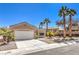Beautiful one-story home featuring desert landscaping, palm trees, and a convenient two-car garage at 1821 Eagle Mesa Ave, Henderson, NV 89012