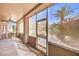 An enclosed outdoor patio with a ceiling fan and view of the backyard landscape at 1821 Eagle Mesa Ave, Henderson, NV 89012