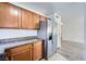 Kitchen features stainless steel appliances, wooden cabinets, and stone countertops at 2110 Sealion Dr # 101, Las Vegas, NV 89128