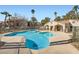 Gorgeous community pool with clear blue water and surrounding palm trees at 2110 Sealion Dr # 101, Las Vegas, NV 89128