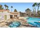 Inviting community pool and spa area with lush landscaping and lounge chairs at 2110 Sealion Dr # 101, Las Vegas, NV 89128