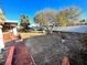 A spacious backyard with a brick patio and mature trees at 2208 E Ogden Ave, Las Vegas, NV 89101