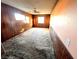 Spacious bedroom featuring natural light, wood paneling, and ceiling fan at 2208 E Ogden Ave, Las Vegas, NV 89101