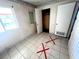 A compact bedroom with tiled floors and patterned wallpaper at 2208 E Ogden Ave, Las Vegas, NV 89101