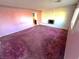 Living room features a decorative fireplace and plush carpet at 2208 E Ogden Ave, Las Vegas, NV 89101
