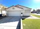 Charming single-story home features a two-car garage, well-maintained lawn, and classic architectural details at 2228 Saint Paul Way, Las Vegas, NV 89104