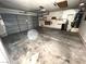 Spacious garage with overhead door, water heater, storage shelving and concrete flooring at 2228 Saint Paul Way, Las Vegas, NV 89104