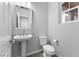 Powder room with pedestal sink, mirror, and toilet at 2231 Desert Prairie St, Las Vegas, NV 89135