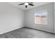 Bedroom with a ceiling fan and large window, and wood-style floors at 2231 Desert Prairie St, Las Vegas, NV 89135