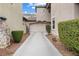 Long driveway leading to a two-car garage, framed by lush landscaping at 2231 Desert Prairie St, Las Vegas, NV 89135