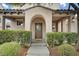 Inviting front entrance with an arched doorway and manicured landscaping at 2231 Desert Prairie St, Las Vegas, NV 89135