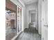 Hallway featuring light wood floors, a glass sliding door to patio, and white doors at 2231 Desert Prairie St, Las Vegas, NV 89135