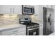 Kitchen featuring stainless steel appliances, a gas range, quartz counters, and white cabinets at 2231 Desert Prairie St, Las Vegas, NV 89135